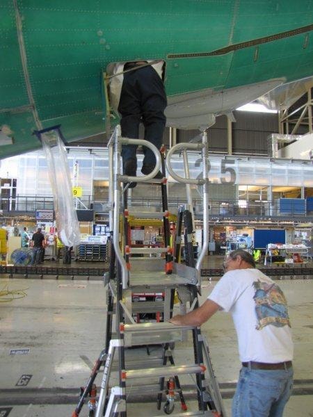 Technicians using Little Giant ladder for aircraft wing maintenance