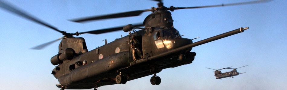 MH-47 Chinook helicopters in flight at dusk
