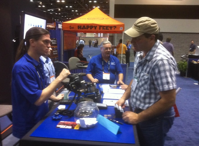Genesis J.I.T. team at trade show demonstrating products